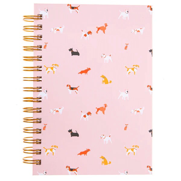 pink spiral notebook decorated with various dog illustrations on the cover